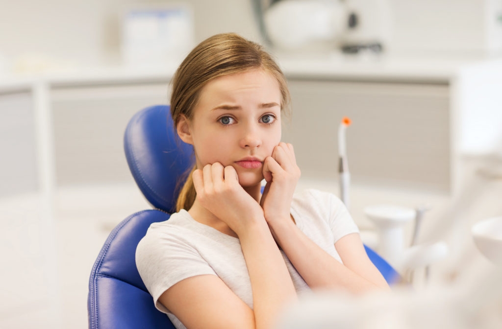 photo of a young girl dental patient who appears to be scared